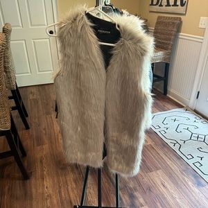 Light grey colored furry vest. Never worn. No tags. Size L/XL